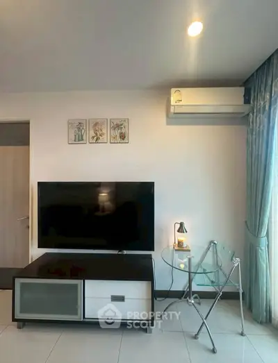 Modern living room with sleek TV setup and stylish glass table