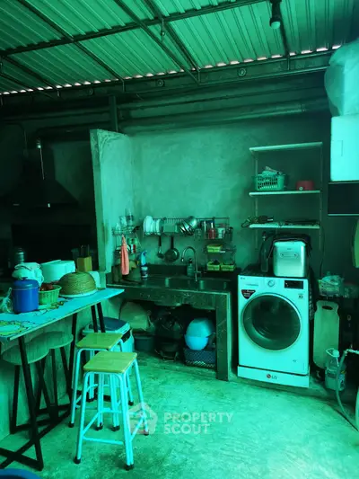 Charming rustic kitchen with washing machine and open shelving, perfect for cozy home living.