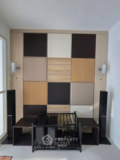 Modern living room with stylish wall paneling and sleek audio setup