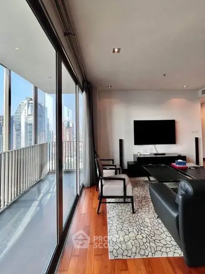 Luxurious living room with floor-to-ceiling windows and stunning city view, featuring modern decor and hardwood floors.