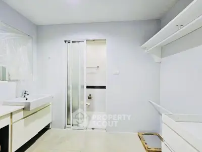 Modern bathroom with sleek fixtures and sliding door