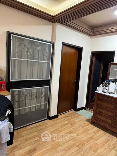 Cozy bedroom with wooden flooring and elegant furniture