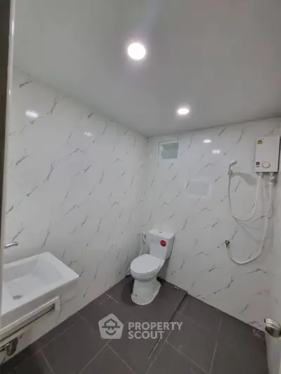 Modern bathroom with sleek design and marble-patterned walls