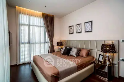 Luxurious bedroom with elegant decor and large window in modern apartment