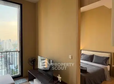 Modern apartment with cozy bedroom and city view balcony, perfect for urban living.
