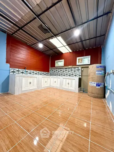 Spacious kitchen with tiled flooring and modern backsplash