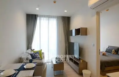 Modern living room with cozy dining area and bedroom view