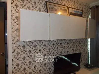 Stylish living room with modern wall cabinets and elegant wallpaper design.