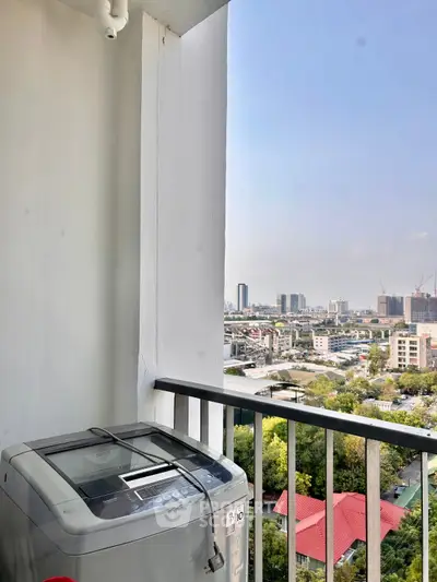 High-rise balcony with washing machine and stunning cityscape view