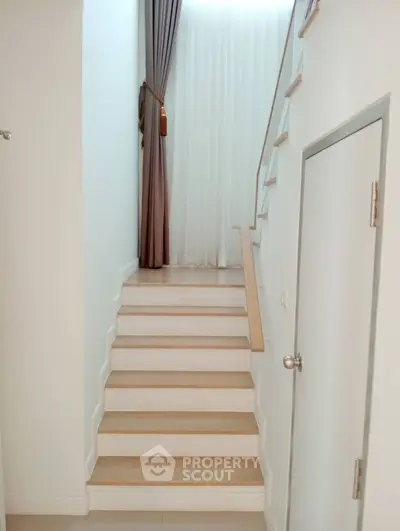 Elegant staircase with modern design and high ceiling in a stylish home