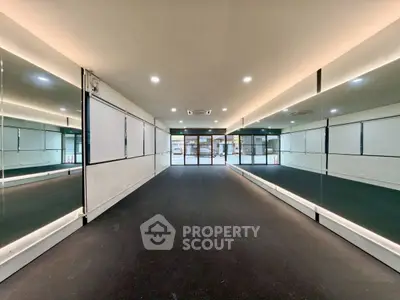 Spacious modern hallway with mirrored walls and sleek lighting