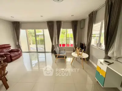 Spacious living room with modern furniture and large windows offering natural light.