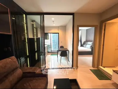 Modern apartment interior with living room, dining area, and bedroom in open layout design.