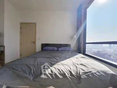 Modern bedroom with city view and ample natural light