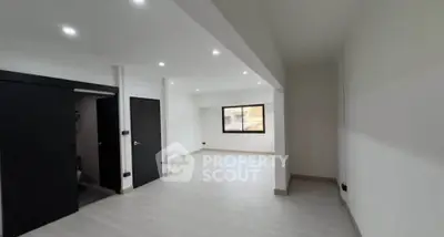 Spacious modern living room with sleek design and ample natural light.
