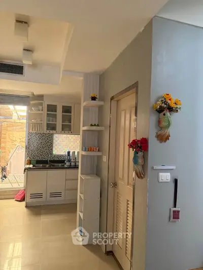 Charming kitchen with modern cabinetry and open layout, featuring stylish decor and ample natural light.