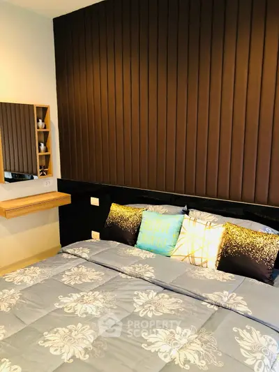 Cozy bedroom with stylish decor and plush bedding