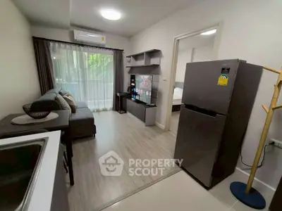 Modern living room with sleek furniture and open layout, featuring a cozy sofa and stylish decor.