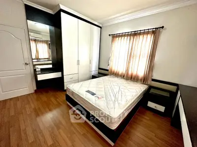 Spacious bedroom with modern furniture and natural light