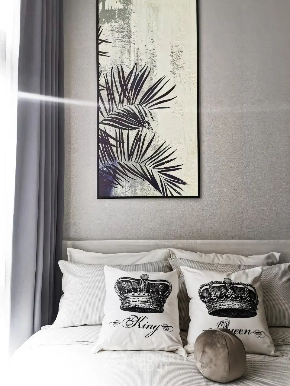 Stylish bedroom with elegant decor and crown-themed pillows