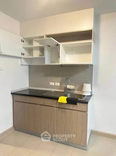 Modern kitchen with open cabinets and sleek design in a contemporary apartment.