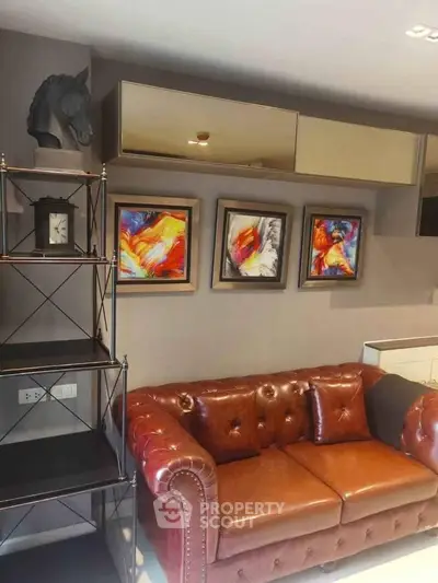 Stylish living room with leather sofa and vibrant artwork, perfect for modern living.
