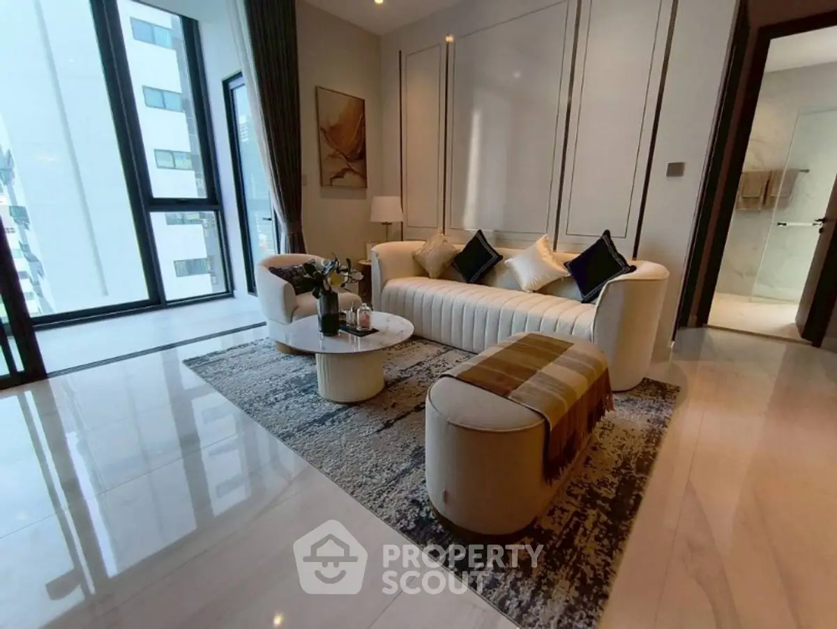 Luxurious modern living room with elegant furniture and large windows in a high-rise apartment.