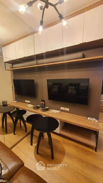 Modern living room with stylish furniture and wall-mounted TV