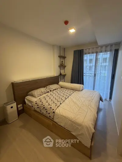 Cozy bedroom with modern decor and balcony view in urban apartment