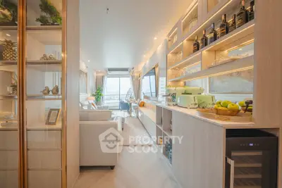 Luxurious modern living room with open kitchen and stunning city view, featuring elegant decor and ample natural light.