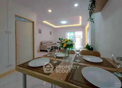 Modern open-plan living and dining area with elegant decor and natural light.