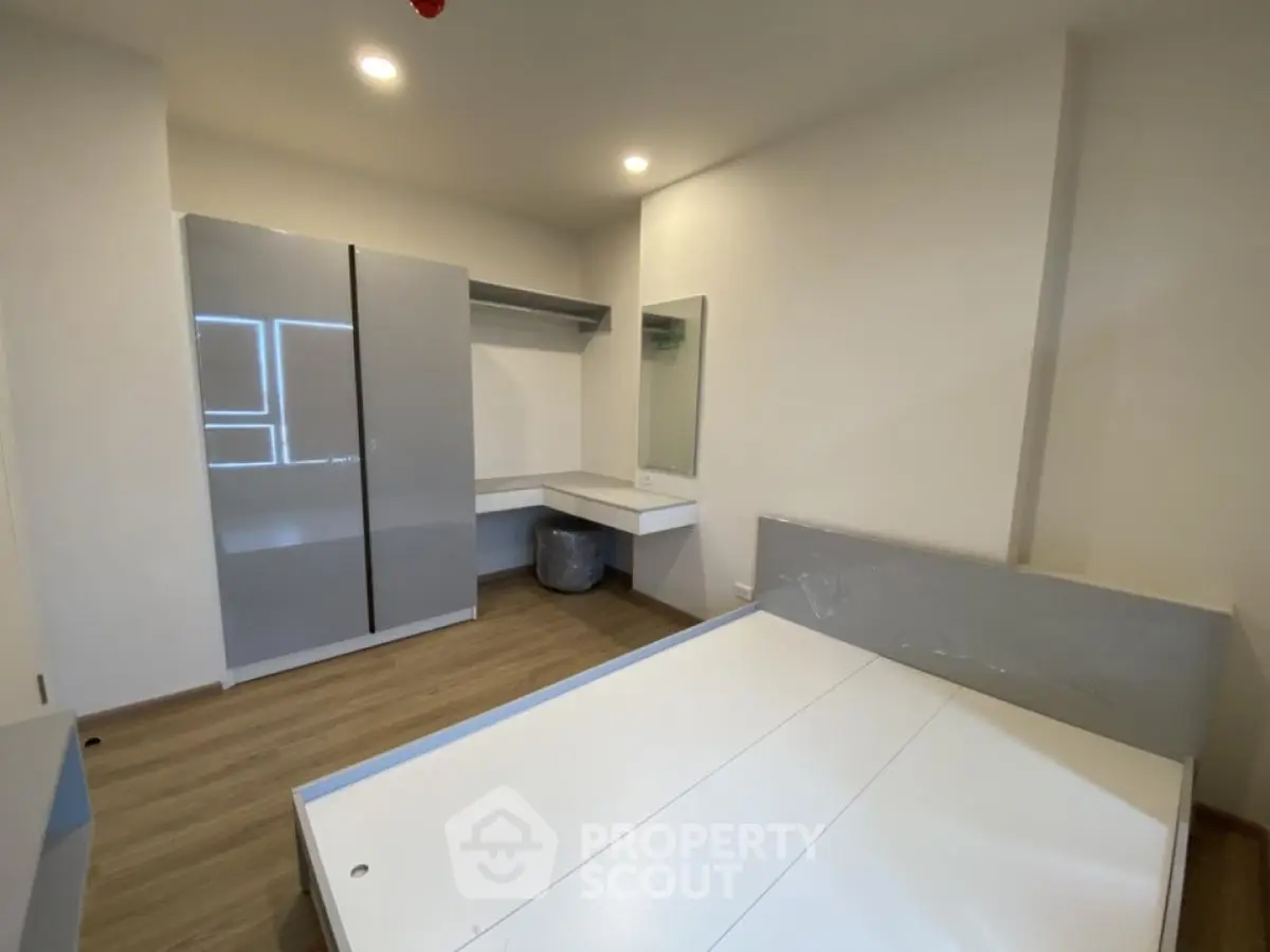 Modern bedroom with sleek furniture and ample storage space
