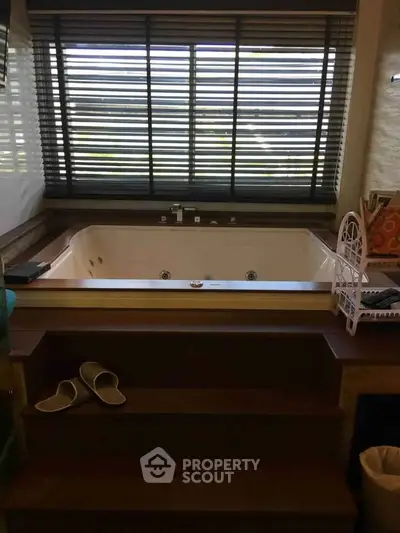 Luxurious bathroom with sunken bathtub and large window view