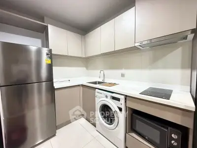 Modern kitchen with sleek appliances and ample storage space