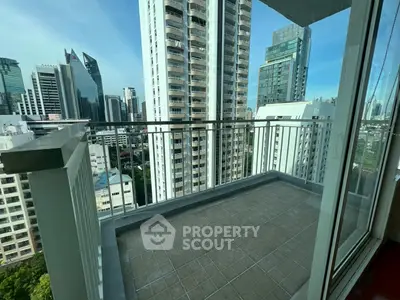 Spacious balcony with stunning cityscape views in a modern high-rise building.