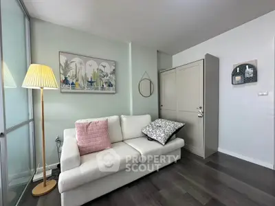 Chic living room with modern decor, cozy white sofa, stylish floor lamp, and elegant wall art.
