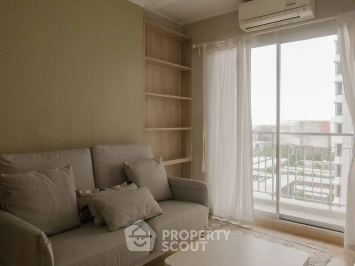 Cozy living room with sofa and balcony view in modern apartment