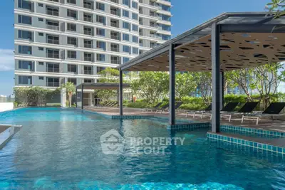 Luxurious high-rise apartment with stunning pool and lush greenery, perfect for relaxation and leisure.
