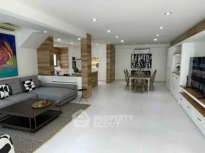 Spacious modern living room with open kitchen and stylish decor