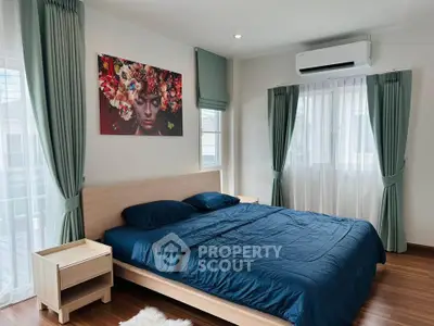 Spacious bedroom with modern decor and natural light