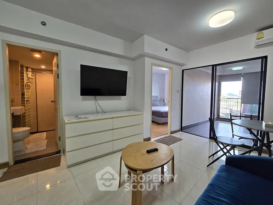 Modern apartment living room with balcony and bedroom view