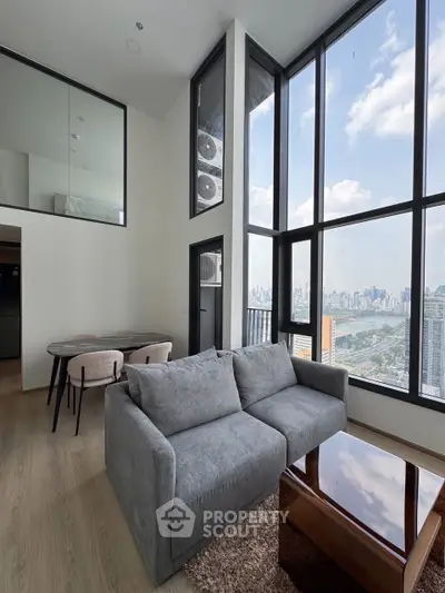 Stunning high-rise living room with floor-to-ceiling windows and cityscape view