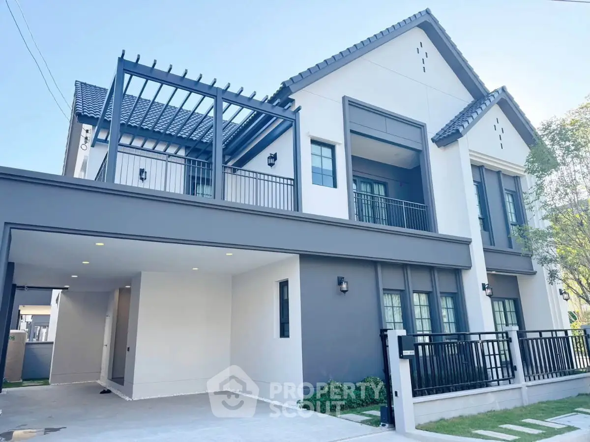 Modern two-story house with sleek design and spacious carport in a serene neighborhood.