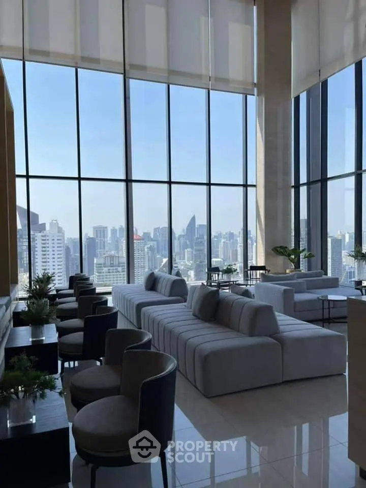 Luxurious high-rise living room with panoramic city views and elegant furnishings.