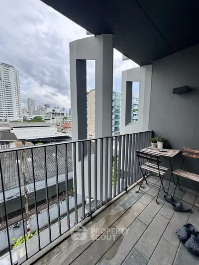 Modern balcony with city view and stylish outdoor furniture