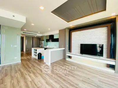 Spacious modern living room with open kitchen and sleek wooden flooring