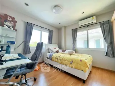 Bright and cozy bedroom with modern furnishings and ample natural light.