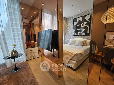 Luxurious modern bedroom with mirrored walls and stylish decor