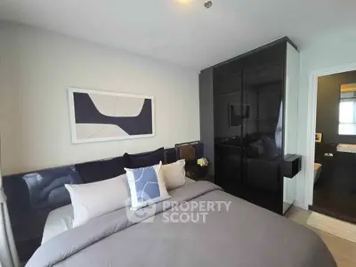 Modern bedroom with sleek black wardrobe and stylish decor