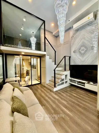 Luxurious modern living room with mezzanine, elegant chandelier, and stylish decor.